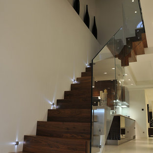 Contemporary wood staircase in London with wood risers.