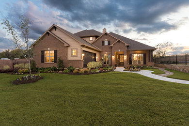 Large transitional multicolored two-story brick house exterior photo in Dallas