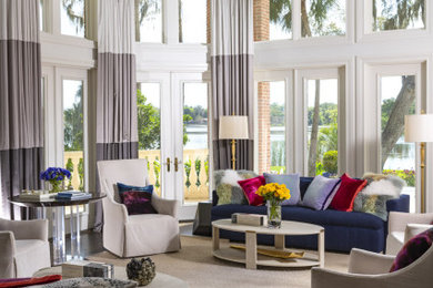 Example of a huge transitional open concept dark wood floor and brown floor living room design in Tampa with white walls, a two-sided fireplace, a stone fireplace and no tv