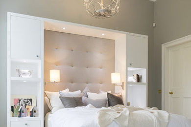 This is an example of a large transitional guest bedroom in London with grey walls, carpet and no fireplace.