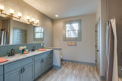 Mid-sized transitional master white tile and porcelain tile vinyl floor and beige floor bathroom photo in Nashville with shaker cabinets, gray cabinets, a two-piece toilet, gray walls, an undermount sink and granite countertops