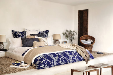 Inspiration for a large beach style master bedroom in Other with white walls and no fireplace.
