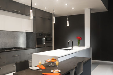 Example of a large trendy galley porcelain tile and white floor eat-in kitchen design in Atlanta with a single-bowl sink, flat-panel cabinets, gray cabinets, quartz countertops, gray backsplash, metal backsplash, stainless steel appliances, an island and gray countertops