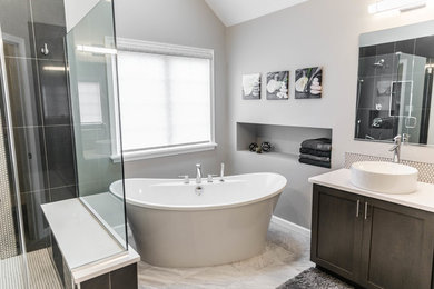 Inspiration for a large contemporary master black tile and porcelain tile porcelain tile and gray floor bathroom remodel in Philadelphia with shaker cabinets, gray cabinets, gray walls, a vessel sink, quartz countertops and a hinged shower door