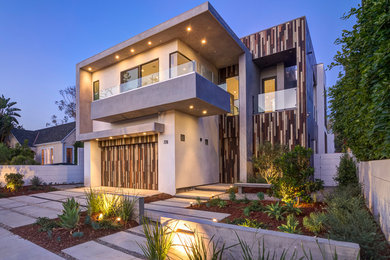 Trendy two-story mixed siding flat roof photo in Los Angeles
