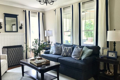 Mid-sized farmhouse enclosed dark wood floor and brown floor living room photo in Atlanta with beige walls, a standard fireplace, a brick fireplace and a concealed tv