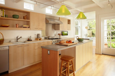 Inspiration for a modern kitchen remodel in San Francisco with flat-panel cabinets, light wood cabinets and metallic backsplash