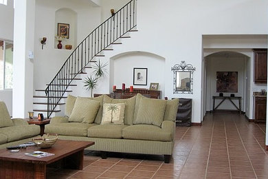 Living room - mid-sized traditional loft-style ceramic tile living room idea in San Diego with white walls, a standard fireplace, a tile fireplace and a media wall