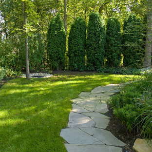Photo of a traditional back fully shaded garden in Chicago with a garden path and natural stone paving.