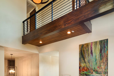 Mid-sized minimalist brown floor and dark wood floor entryway photo in Austin with white walls