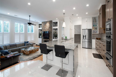 Example of a mid-sized minimalist galley porcelain tile and white floor eat-in kitchen design in Dallas with flat-panel cabinets, brown cabinets, a peninsula, gray countertops, an undermount sink, quartzite countertops, white backsplash and stainless steel appliances