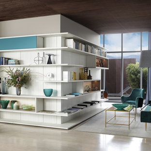 This is an example of a medium sized contemporary open plan home cinema in Los Angeles with white walls, laminate floors and beige floors.