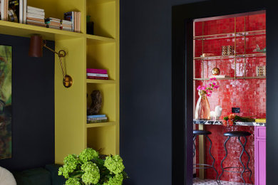Trendy carpeted and white floor home office library photo in Los Angeles with black walls