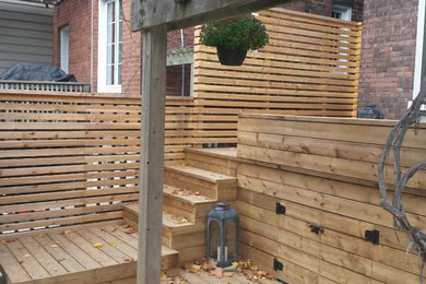 Design ideas for a small modern partial sun backyard outdoor basketball/tennis/multi-game court in Toronto with decking for summer.