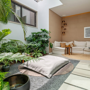 Indoor garden with tropical planting and floor cushion, Alfragide