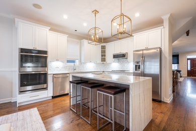 Eat-in kitchen - mid-sized transitional l-shaped eat-in kitchen idea in Chicago with shaker cabinets, white cabinets, glass countertops and an island