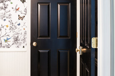 Inspiration for a small timeless ceramic tile and multicolored floor powder room remodel in Other with raised-panel cabinets, black cabinets, a two-piece toilet, multicolored walls, an undermount sink, marble countertops and gray countertops