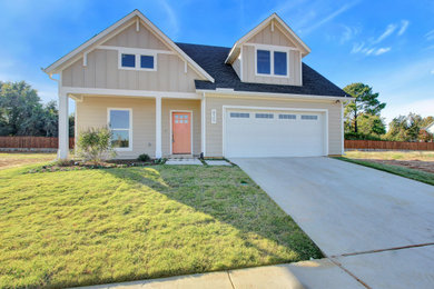 Country beige two-story concrete fiberboard house exterior photo in Dallas with a shingle roof
