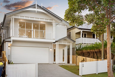 Inspiration for a mid-sized transitional two-storey white house exterior in Brisbane with concrete fiberboard siding, a gable roof, a metal roof, a black roof and clapboard siding.