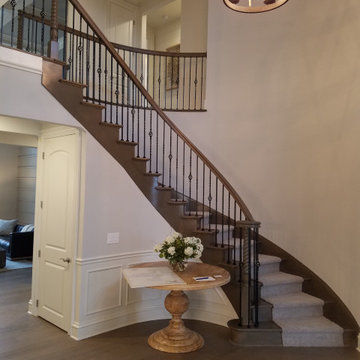 Grand Circular Wood and Carpet Staircase with Iron Balusters