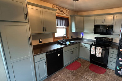 Example of a mid-sized transitional l-shaped eat-in kitchen design in Other with shaker cabinets and green cabinets