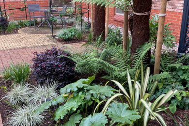 Photo of a small eclectic courtyard partial sun garden in Buckinghamshire with a flowerbed.