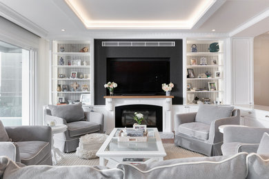 Large beach style open concept living room in Sydney with white walls, medium hardwood floors, a standard fireplace, a stone fireplace surround, recessed, decorative wall panelling and a built-in media wall.