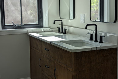 Inspiration for a master porcelain tile and double-sink bathroom remodel in Other with flat-panel cabinets, medium tone wood cabinets, an undermount sink, quartz countertops, white countertops and a built-in vanity