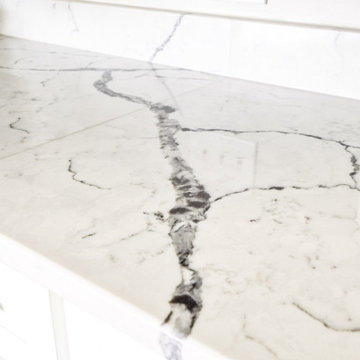 Navy Stained Island, Hood vent and Floating Shelves in White Shaker Kitchen