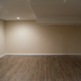 Photo of a medium sized classic fully buried basement in New York with beige walls, no fireplace and medium hardwood flooring.