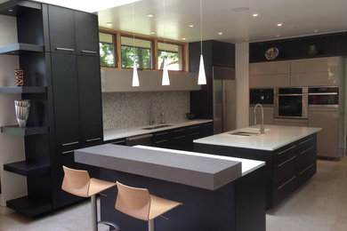 Inspiration for a large contemporary u-shaped eat-in kitchen in Oklahoma City with a single-bowl sink, flat-panel cabinets, dark wood cabinets, quartz benchtops, beige splashback, glass tile splashback, stainless steel appliances, limestone floors and multiple islands.