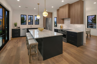 Photo of a mid-sized contemporary kitchen in Seattle with flat-panel cabinets, marble benchtops, with island and white benchtop.