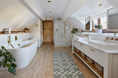 Inspiration for a medium sized contemporary ensuite bathroom in Buckinghamshire with white cabinets, a built-in bath, a built-in shower, a wall mounted toilet, white tiles, porcelain tiles, white walls, porcelain flooring, a built-in sink, quartz worktops, beige floors, a hinged door, white worktops, double sinks and a built in vanity unit.