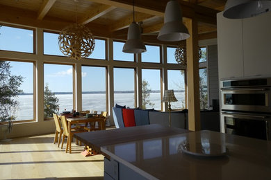 Open concept kitchen - mid-sized contemporary l-shaped light wood floor and beige floor open concept kitchen idea in Other with a single-bowl sink, flat-panel cabinets, white cabinets, quartzite countertops, white backsplash, glass tile backsplash, stainless steel appliances, an island and white countertops