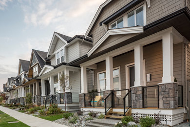 Inspiration for a mid-sized transitional beige three-story concrete fiberboard exterior home remodel in Vancouver with a shingle roof