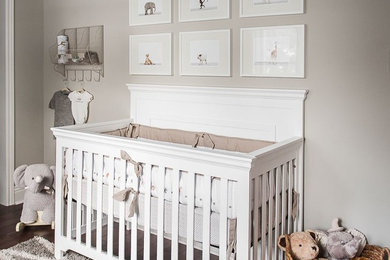 Inspiration for a mid-sized transitional gender-neutral dark wood floor nursery remodel in Toronto with gray walls