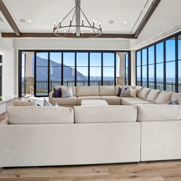 Great Room Sectional Frames Mountain Views Behind a Wall of Folding Glass Doors