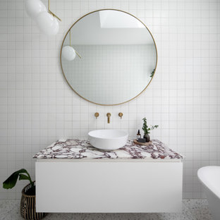 Inspiration for a mid-sized contemporary kids bathroom in Melbourne with white cabinets, a claw-foot tub, an open shower, white tile, porcelain tile, terrazzo floors, a pedestal sink, marble benchtops, white floor, an open shower, pink benchtops, a single vanity and a floating vanity.