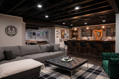 Inspiration for a large underground vinyl floor, brown floor and exposed beam basement game room remodel in Detroit