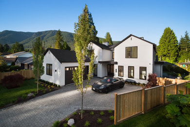 Inspiration for a large transitional white two-story stucco exterior home remodel in Vancouver