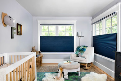 Photo of a mid-sized transitional gender-neutral kids' room in Baltimore with grey walls and light hardwood floors.