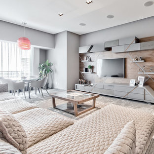 This is an example of a small modern enclosed home cinema with grey walls, marble flooring, a wall mounted tv and grey floors.