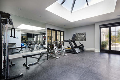 This is an example of a large transitional multipurpose gym in Toronto with white walls and black floor.