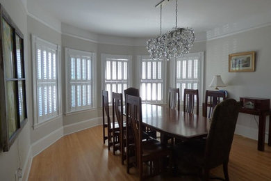 Photo of a mid-sized transitional separate dining room in Portland with beige walls, light hardwood floors and beige floor.