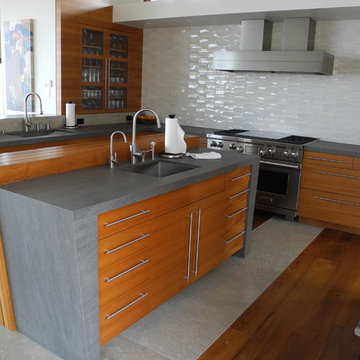 Gray and medium wood kitchen with white backsplash tile and wood floors