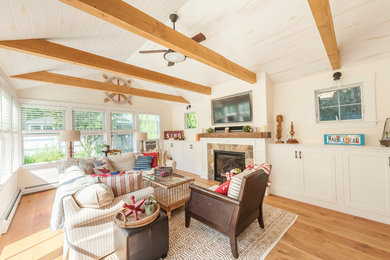 Beach style light wood floor family room photo in Boston with a standard fireplace and a stone fireplace