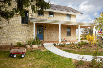 Farmhouse home design photo in Milwaukee