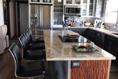 Eat-in kitchen - contemporary eat-in kitchen idea in Hawaii with granite countertops, multicolored backsplash, glass tile backsplash, stainless steel appliances and an island