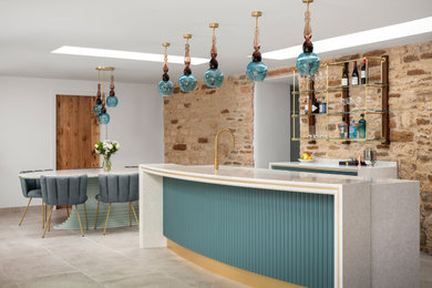 Large contemporary single-wall home bar in Other with an integrated sink, shaker cabinets, blue cabinets, engineered stone countertops, white splashback, engineered quartz splashback, beige floors, white worktops and a feature wall.