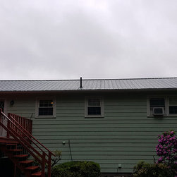 Metal Roof on Split-level Home - Roofing And Gutters